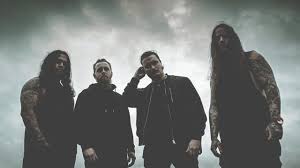 Rock band posing under a dark, dramatic sky, showcasing their edgy style and attitude.