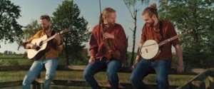 Bluegrass musicians playing instruments in a vibrant outdoor jam session.