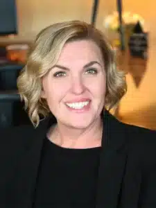 Erin Emerson, President of Perry County Development Corporation smiling in a professional setting, showcasing confidence and warmth.