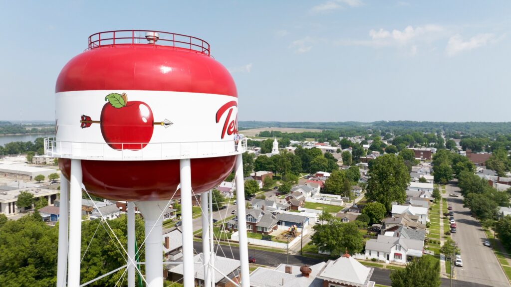 Apple-themed water tower in the scenic Apple City surrounded by residential neighborhoods.