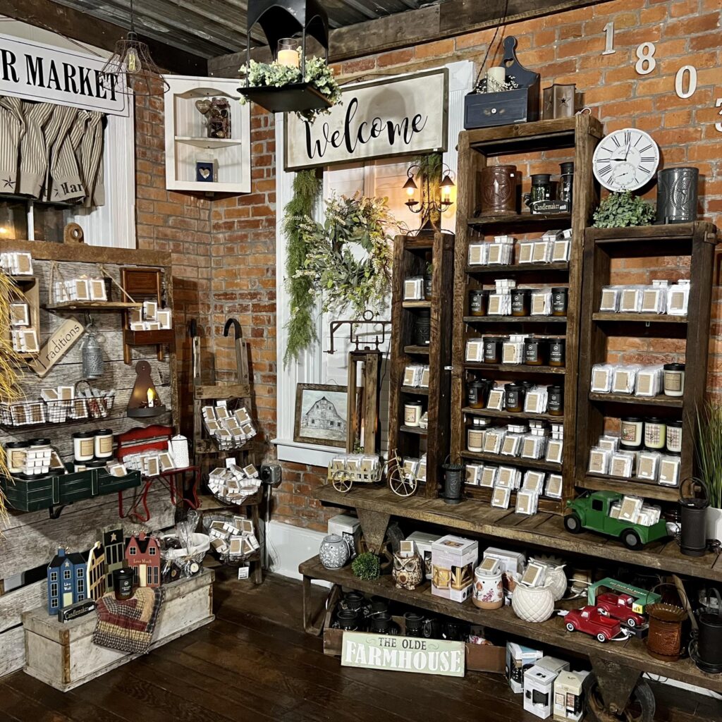 Charming farmhouse decor shop featuring candles, country-inspired accents, and rustic displays.