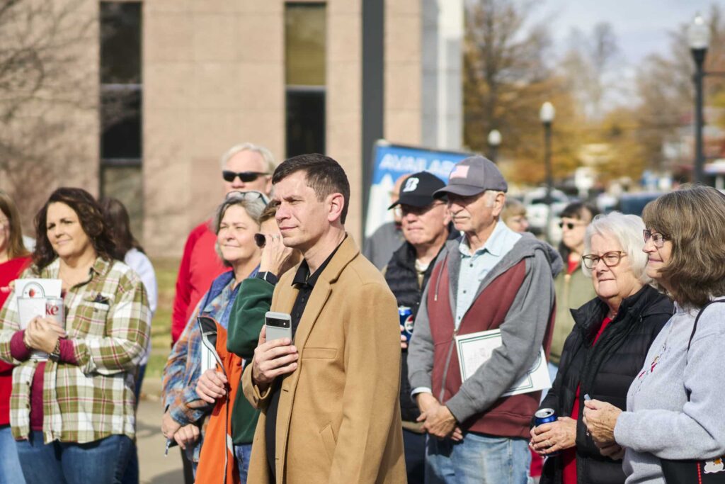 Crowd gathers at a lively outdoor event, showcasing community engagement and participation.