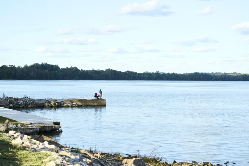 Fishing by the serene lake, enjoying nature and peaceful moments outdoors.