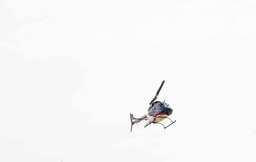 Helicopter flying high in the sky showcasing its powerful rotor blades.