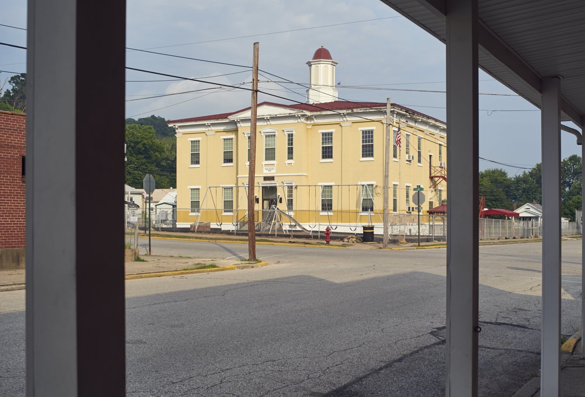 Historic yellow building on a street, showcasing architectural significance and charm.