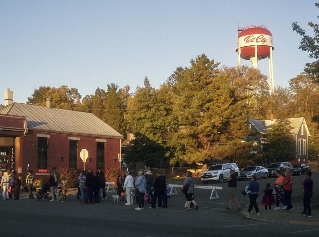 Community event under the Tell City water tower with families and children gathering.