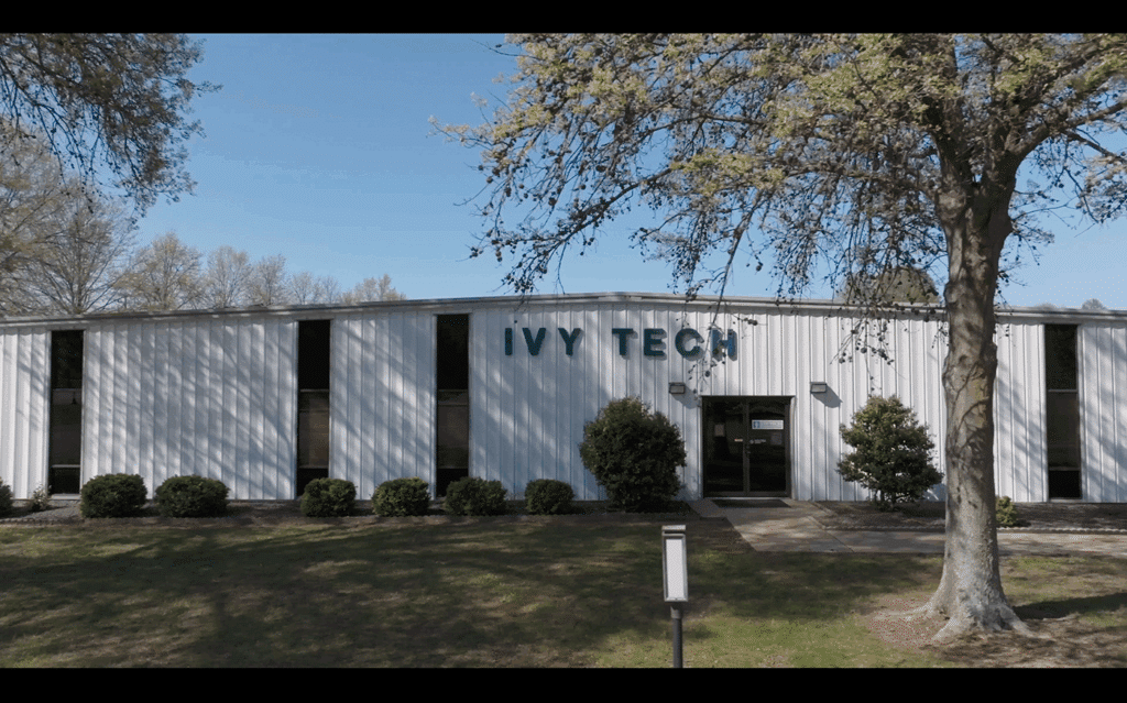 Ivy Tech campus building with clear skies and landscaped surroundings.
