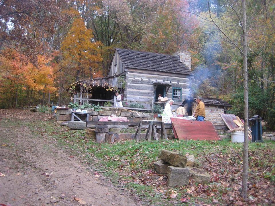 Cozy log cabin surrounded by autumn colors during a gathering in the countryside.